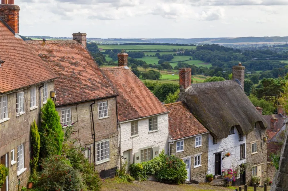 Old English houses with red roof tiles and thatched roofs