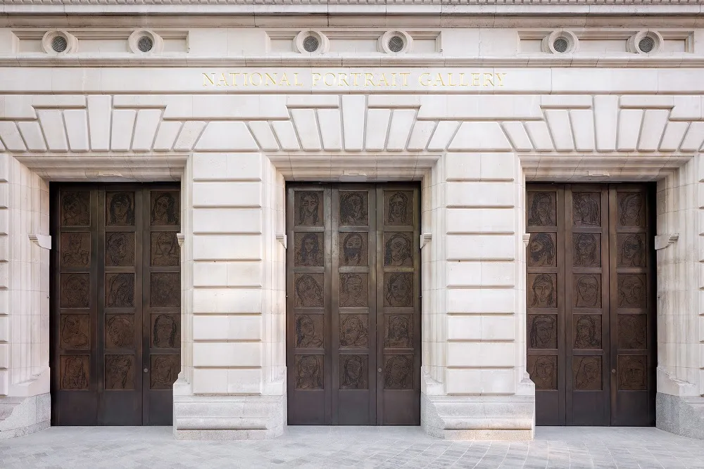 Front view of the National Portrait Gallery entrance featuring ornate doors with artistic carvings and a grand stone facade.