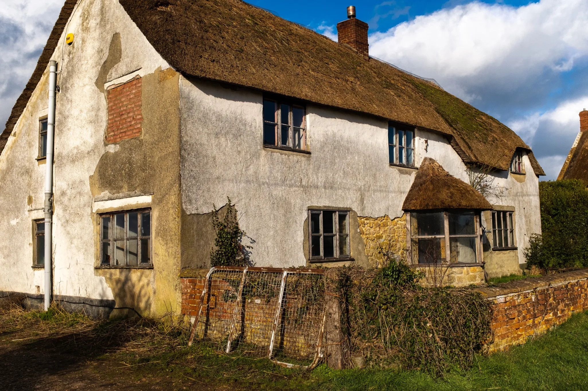 Empty run down thatched cottage