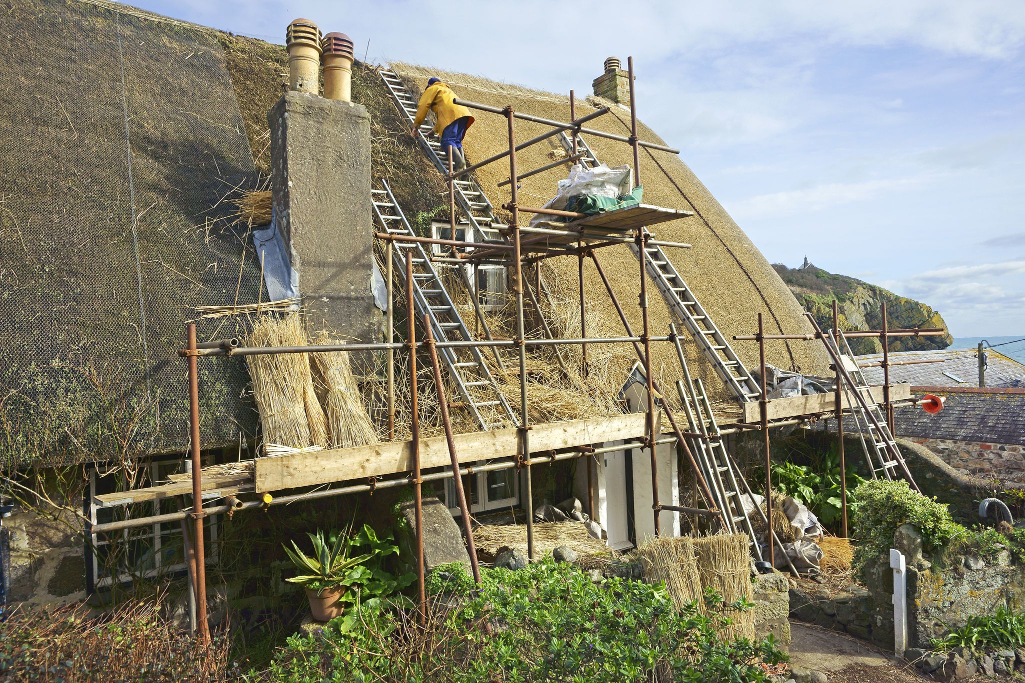 thatched roof being rethatched